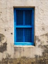 Closed blue window with shutters in the window opening of an old building or house Royalty Free Stock Photo