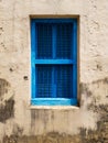 Closed blue window with shutters in the window opening of an old building or house Royalty Free Stock Photo