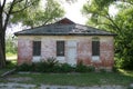 Closed boarded overgrown abandoned rural town building