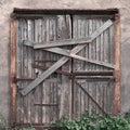 Closed, boarded-up old wooden door. Old abandoned house.