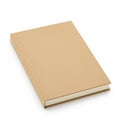 A closed book with a plain brown hardcover rests on a white surface. The book\'s edge Royalty Free Stock Photo