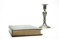 Closed book on the table. Ancient Bible. candlestick. On white background.