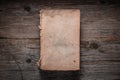 Closed book on vintage wooden background.  Old book on the wooden table. Closed book with empty cover laying on wooden table Royalty Free Stock Photo