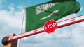 Closed boom gate on the Saudi Arabian flag background. Restricted entry or certain ban in Saudi Arabia. 3D rendering