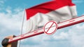 Closed boom gate with no immigration sign on the Indonesian flag background. Border closure or immigration ban in