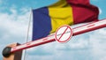 Closed boom gate with no immigration sign on the Romanian flag background. Border closure or immigration ban in Romania