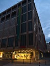 Closed branch of department store chain Galeria Kaufhof with illuminated entrance during Covid-19 lockdown in twilight.