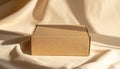 Closed Cardboard Box on Textured Fabric with Soft Sunlight Shadows packaging shipping Royalty Free Stock Photo