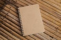 Closed Brown note book on a bamboo background, simple texture