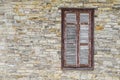 ÃÂ¡losed brown shuttered window in the wall of the light artificial stone Royalty Free Stock Photo