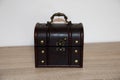Closed brown treasure chest on a wooden surface Royalty Free Stock Photo