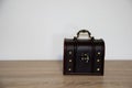 Closed brown treasure chest on a wooden surface Royalty Free Stock Photo