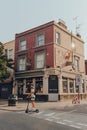 Closed Bucks Head pub in Camden Town, London, UK, man on electric scooter rides past, motion blur Royalty Free Stock Photo