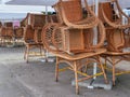 Closed cafe restaurant with rattan whicker chairs, cane-chairs stacked upon tables outdoor Royalty Free Stock Photo