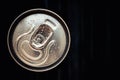 Closed can of cola on black background. Top view. Can drink with water drops. Copy, text space Royalty Free Stock Photo