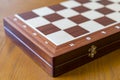 Closed checkerboard close-up. Closed chessboard for chess game on wooden table