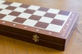 Closed checkerboard close-up. Closed chessboard for chess game on wooden table