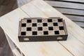 Closed chessboard for chess game on wooden table