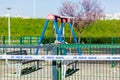 Closed children playground due to corona virus pandemic, with white tape across the gate