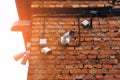 Closed circuit camera Multi-angle CCTV system. a row of cameras hung on an old brick wall Royalty Free Stock Photo