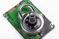 Closed code padlock laying on top of a HDD hard drive, object detail, closeup, disk data encryption, files locker password