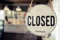 Closed. coffee cafe shop text on vintage sign board hanging on glass door in modern cafe shop reopen after coronavirus quarantine