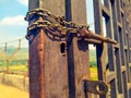 Closed corrosion old big metallic gate by metal chaim Royalty Free Stock Photo