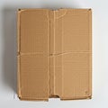 A closed corrugated cardboard box is displayed on a white surface. The box has Royalty Free Stock Photo