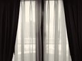 Closed dark curtain with light from window background