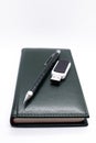 Closed dark green leather imitation notebook with pencil and usb Royalty Free Stock Photo