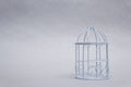 Closed decorative bird cage on a light background. Royalty Free Stock Photo