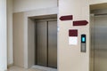 Closed elevator doors. Shiny metal elevator doors in a new modern elevator. An empty hall on the floor of an office building Royalty Free Stock Photo