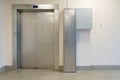 Closed elevator doors. Shiny metal elevator doors in a new modern elevator. An empty hall on the floor of an office building Royalty Free Stock Photo