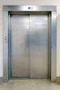 Closed elevator doors. Shiny metal elevator doors in a new modern elevator. An empty hall on the floor of an office building Royalty Free Stock Photo