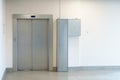 Closed elevator doors. Shiny metal elevator doors in a new modern elevator. An empty hall on the floor of an office building