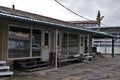 Closed, empty and aged market stands and stalls. Destroyed and broken asphalt on the market at the end of the day