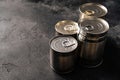 Closed food tin cans on dark background Royalty Free Stock Photo