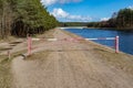 Closed forest path by the water channel. A barrier on a forest duke by the river Royalty Free Stock Photo