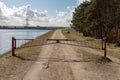 Closed forest path by the water channel. A barrier on a forest duke by the river Royalty Free Stock Photo