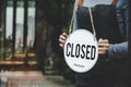 Closed. friendly waitress wearing protection face mask turning open sign board on glass door in modern cafe coffee shop, cafe rest Royalty Free Stock Photo