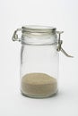 Closed glass jar with sand