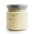 Closed glass jar of white garlic and herb sauce. in low