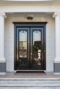 Closed Glossy Black and Glass Front Doors of an Upscale Home