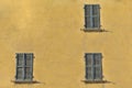 Closed green windows on yellow wall of old house in Florence cit Royalty Free Stock Photo