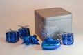 Closed grey gift box with text and blue decoration