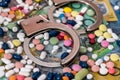 Closed handcuffs with colourful pills on australian dollar background