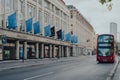 Closed Heals store in Tottenham Court Road, London, UK, bus driving past on an empty street