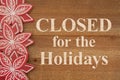 Closed for the Holidays message with wood poinsettias Royalty Free Stock Photo