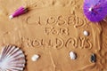 Closed for holidays written on sand Royalty Free Stock Photo