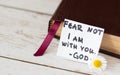 Closed Holy Bible with a handwritten inspiring note: Fear not, I am with you - God.